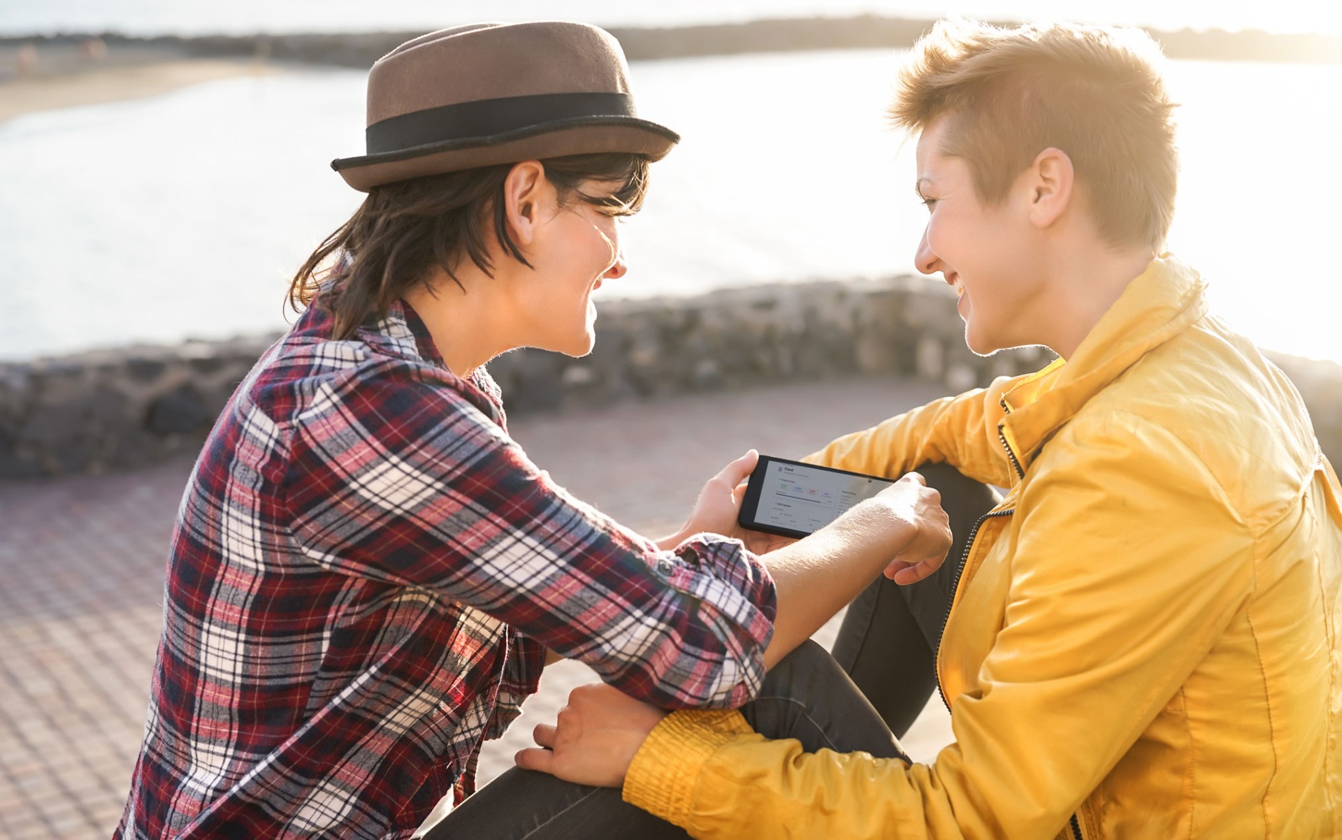 Couple collaborating on budget planning with mobile device